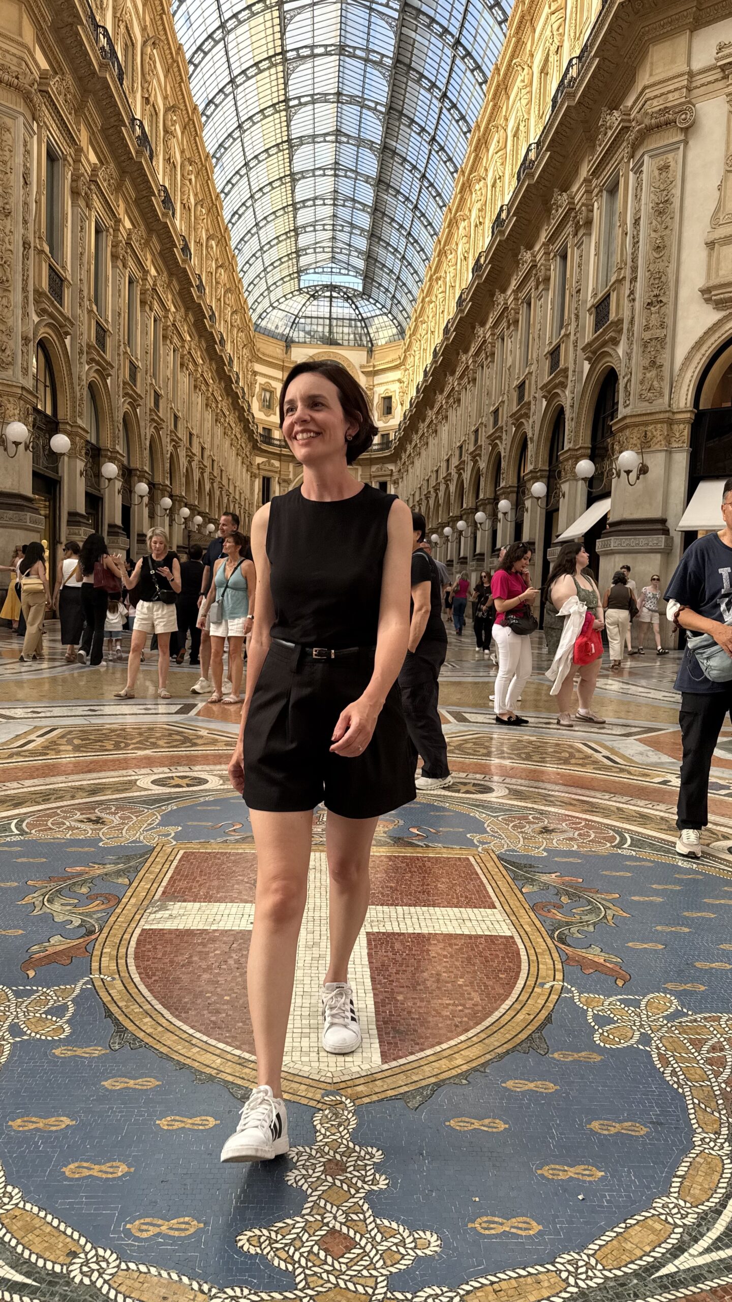 Mulher caminhando sobre o mosaico da Galeria Vittorio Emanuele II em Milão