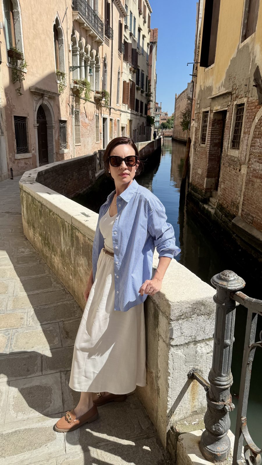 Carol posando em ponte de canal estreito no centro histórico de Veneza