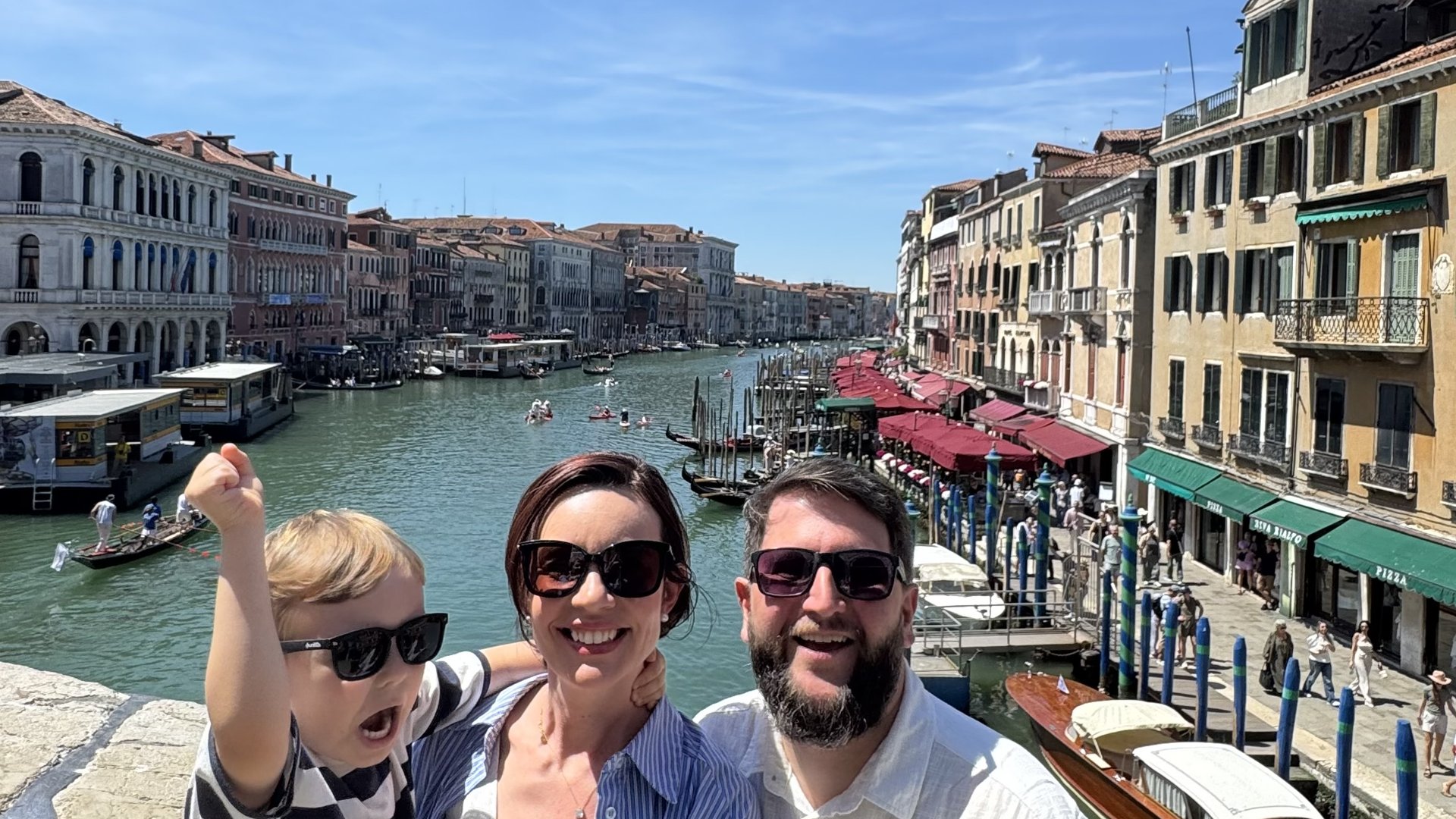 Familia com Samuel comemorando na Ponte de Rialto com vista do Canal Grande em Veneza