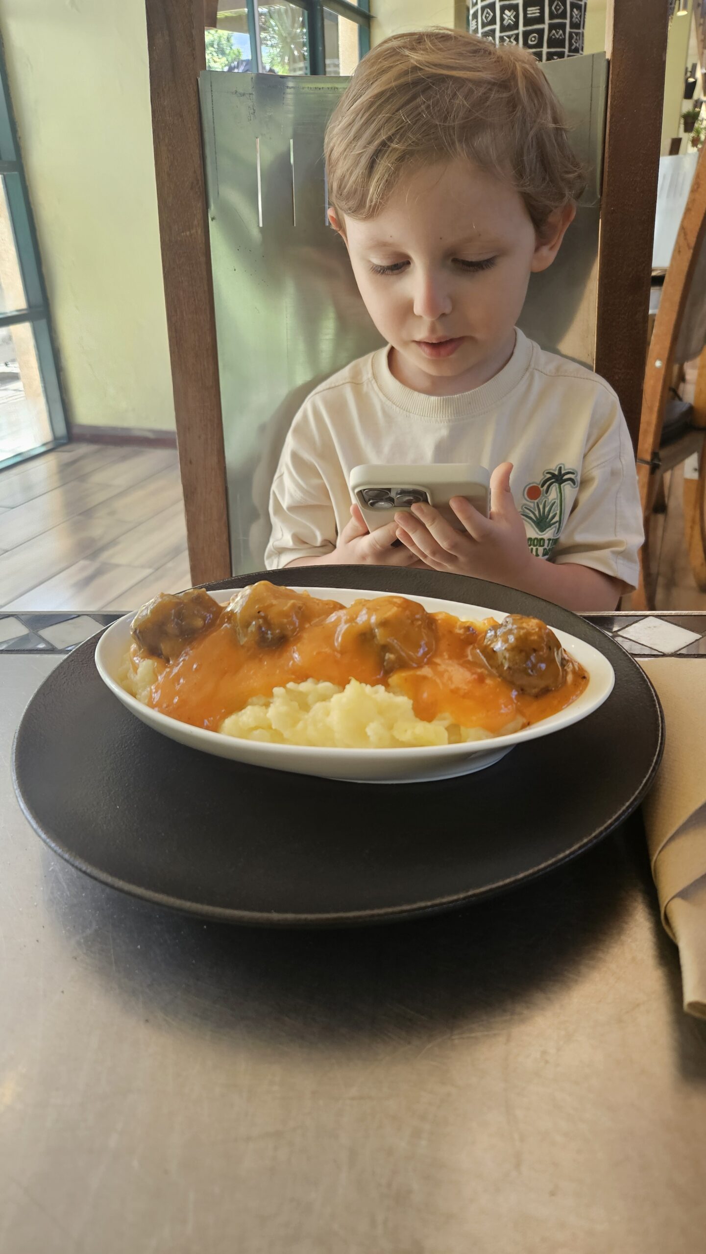 Samuel almoçando bobotie com purê de batata na Cidade do Cabo
