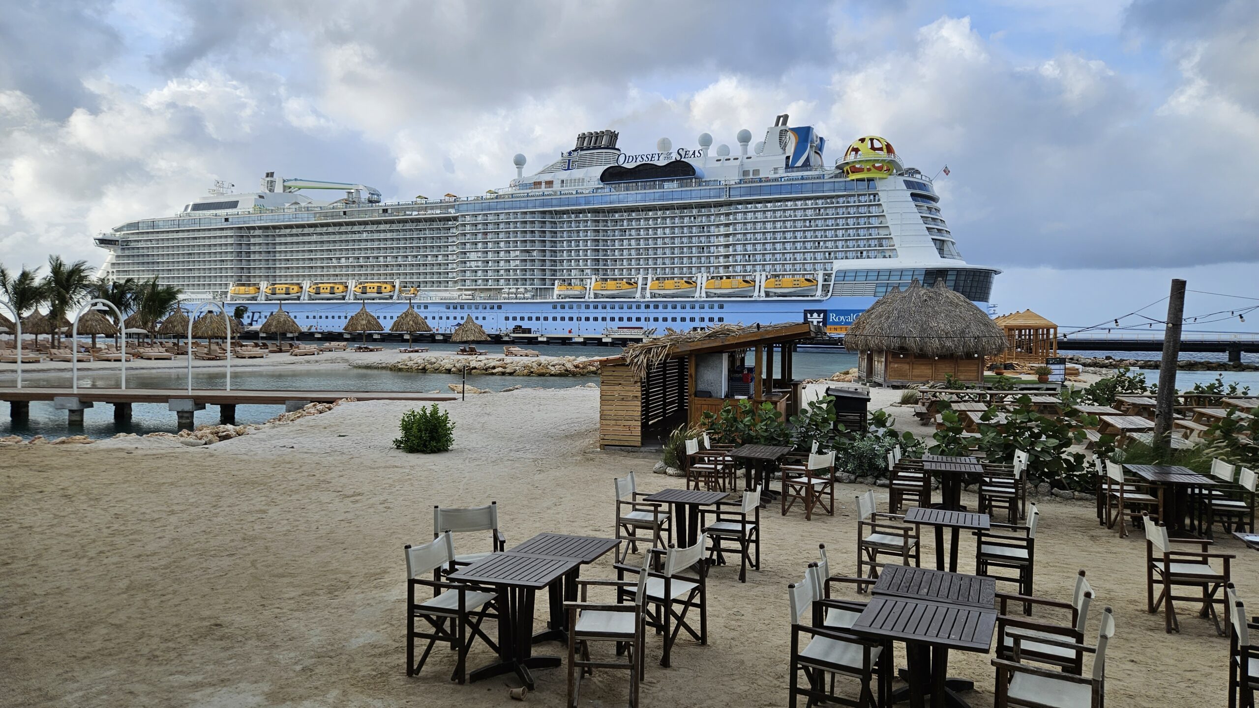 Praia em Curaçao com navio de cruzeiro Odyssey of the Seas atracado ao fundo